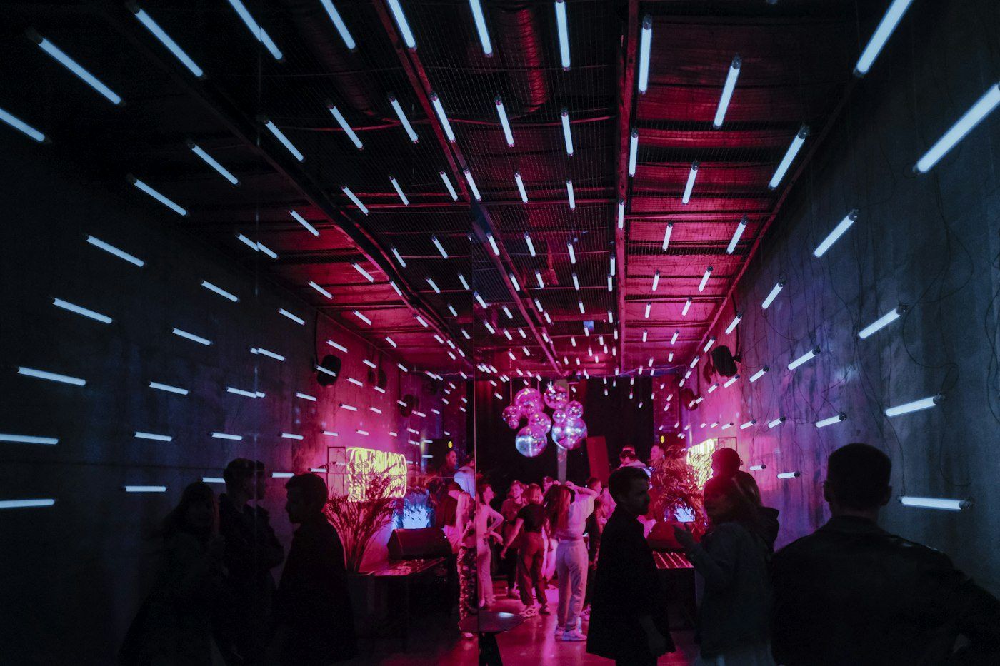 Crowd under a tunnel of club lights