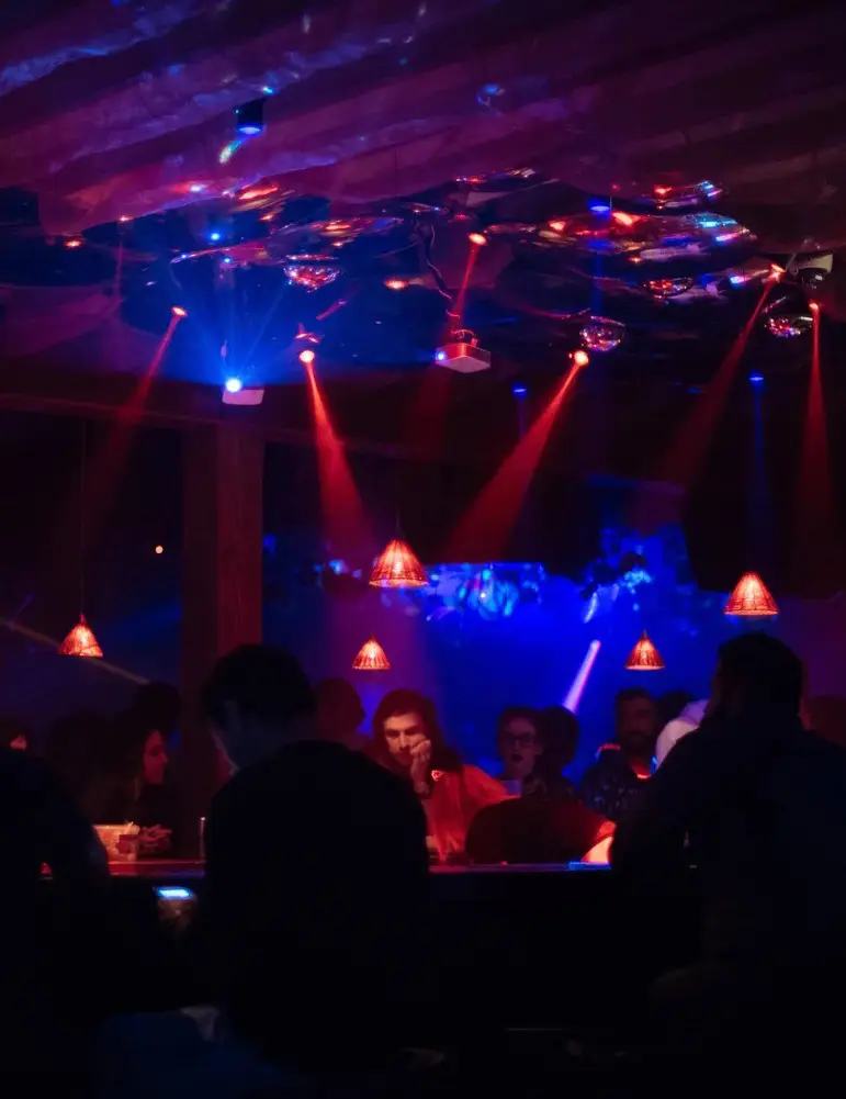 The Gorg-O-Mish bar under red beams and hanging mirrors
